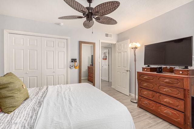 bedroom featuring a closet, ceiling fan, and light hardwood / wood-style flooring