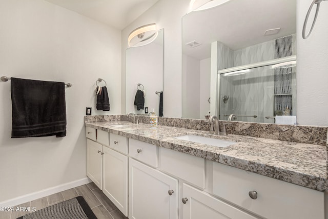 bathroom with a shower with door, wood-type flooring, and vanity