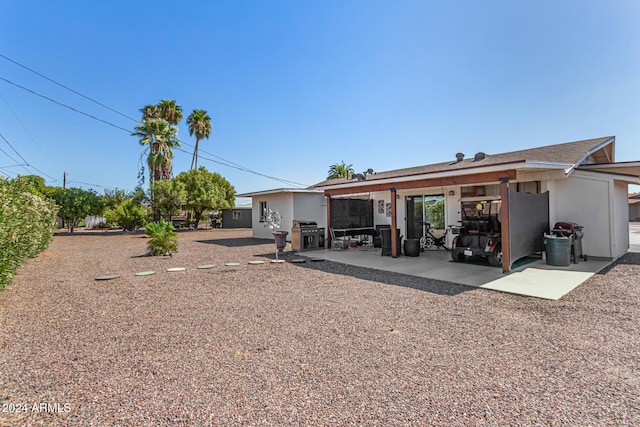 back of house with a patio