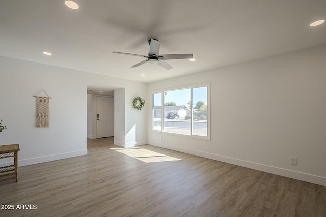 spare room featuring ceiling fan and light hardwood / wood-style flooring