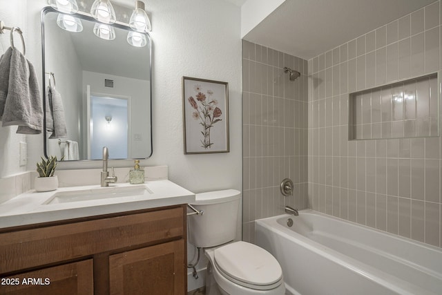 full bathroom with vanity, toilet, and tiled shower / bath combo