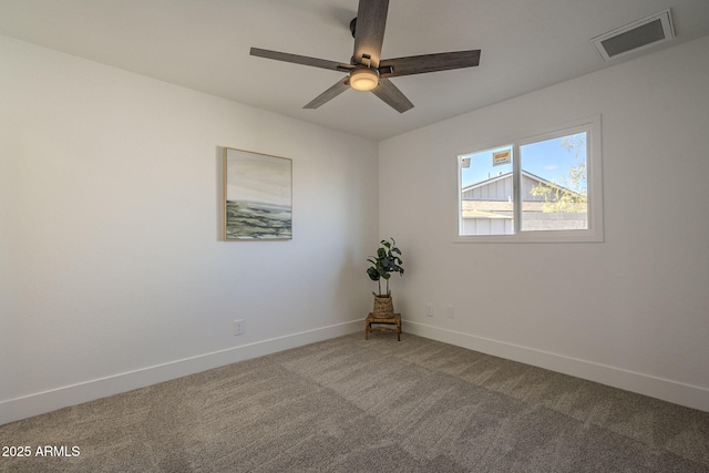 unfurnished room with ceiling fan and carpet