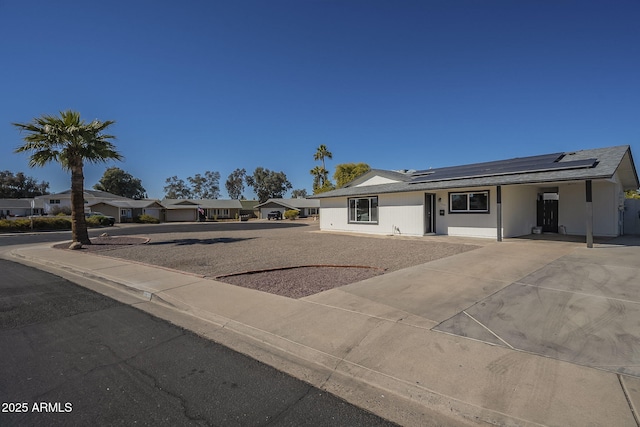 view of front of home featuring a garage and solar panels