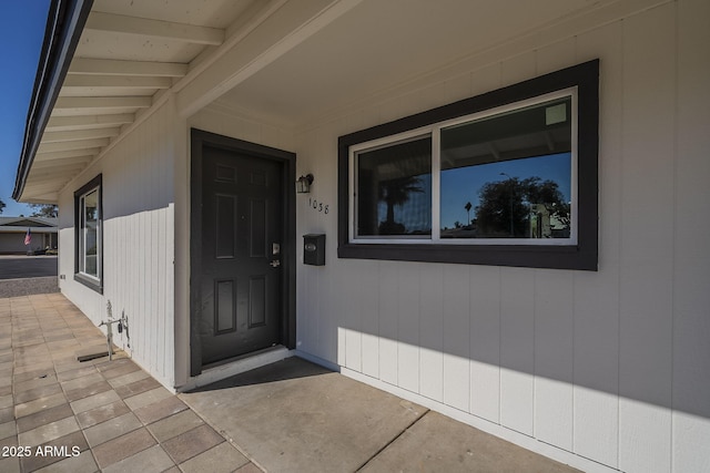 view of exterior entry featuring a patio area