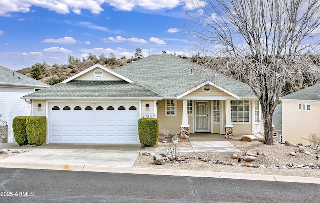 ranch-style home with a garage, concrete driveway, and a shingled roof