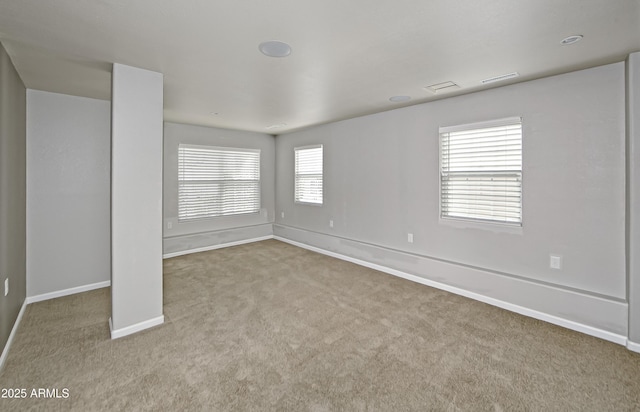 unfurnished room with baseboards and carpet