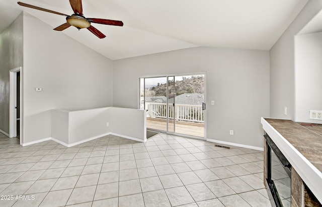 unfurnished living room featuring baseboards, light tile patterned floors, a ceiling fan, and lofted ceiling