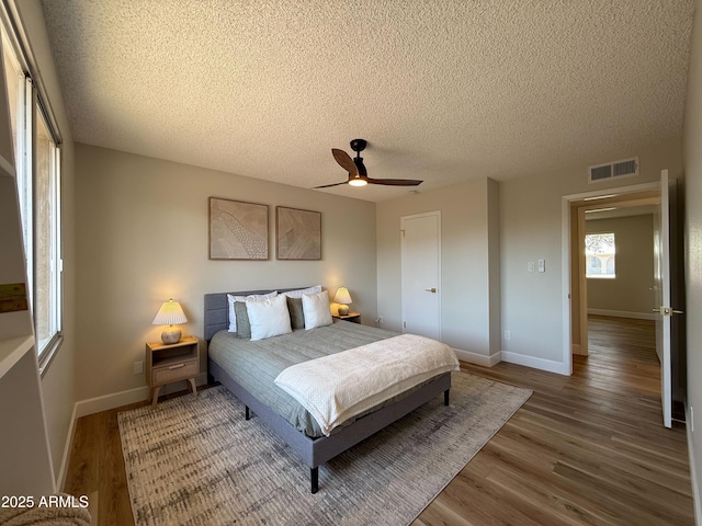 2337 E Manhatton Dr, Tempe, AZ 85282 - bedroom with wood finished floors, baseboards, a textured ceiling, and ceiling fan