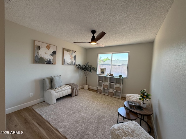 2337 E Manhatton Dr, Tempe, AZ 85282 - living area featuring wood finished floors, a textured ceiling, a ceiling fan, and baseboards