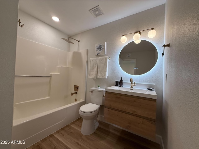 2337 E Manhatton Dr, Tempe, AZ 85282 - full bathroom featuring toilet, wood finished floors, shower / bathtub combination, vanity, and a textured wall