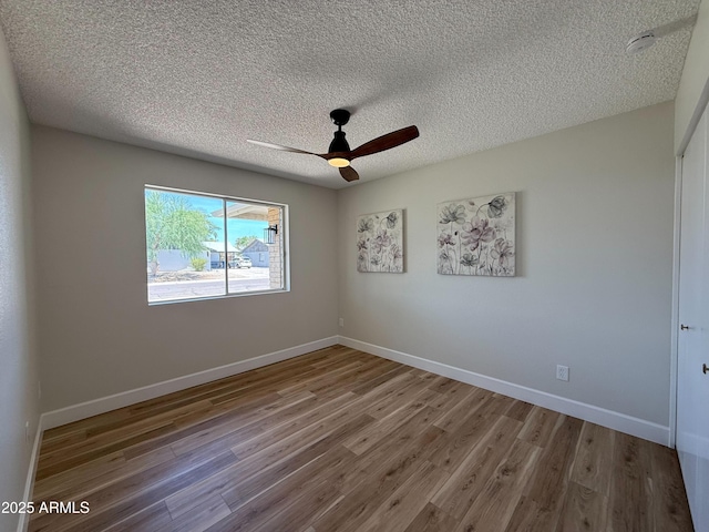 2337 E Manhatton Dr, Tempe, AZ 85282 - spare room featuring wood finished floors, a ceiling fan, a textured ceiling, and baseboards