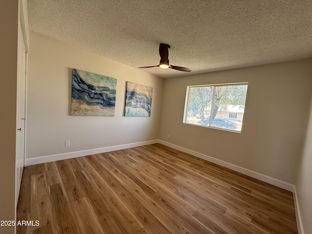 2337 E Manhatton Dr, Tempe, AZ 85282 - spare room with a textured ceiling, a ceiling fan, wood finished floors, and baseboards