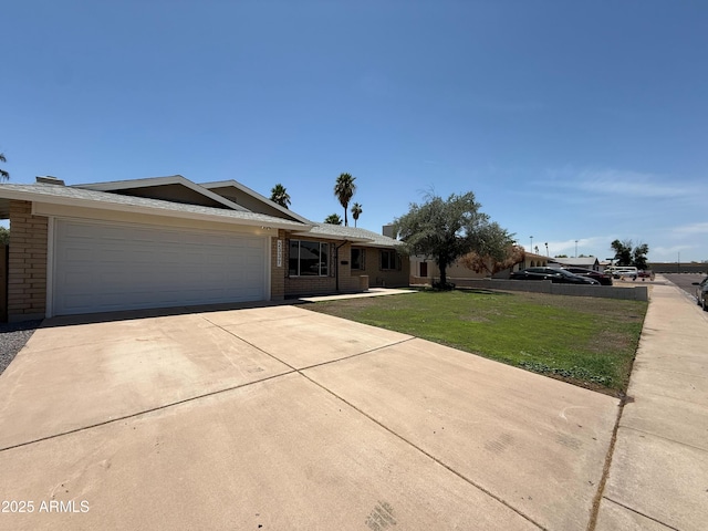 2337 E Manhatton Dr, Tempe, AZ 85282 - ranch-style home featuring brick siding, driveway, a garage, and a front lawn