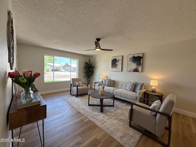 2337 E Manhatton Dr, Tempe, AZ 85282 - living room featuring wood finished floors, ceiling fan, baseboards, and a textured ceiling