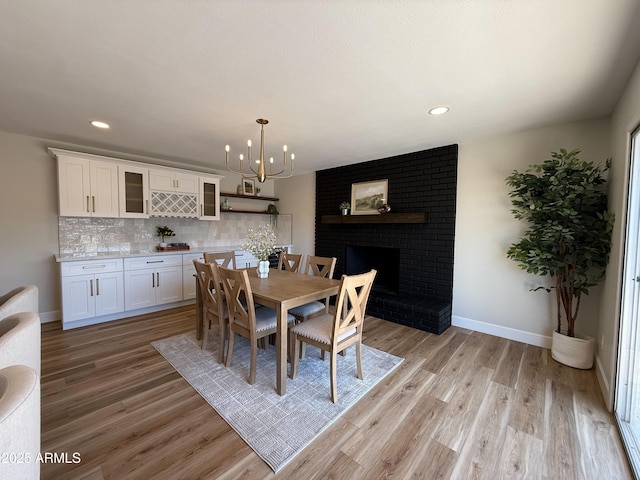 2337 E Manhatton Dr, Tempe, AZ 85282 - dining area featuring baseboards, light wood-style flooring, recessed lighting, a chandelier, and a brick fireplace