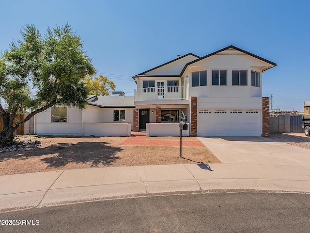 13438 N 18th Ln, Phoenix, AZ 85029 - view of front facade featuring a garage, concrete driveway, and a balcony