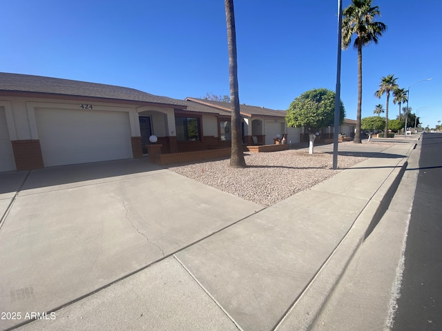 ranch-style house with driveway and an attached garage