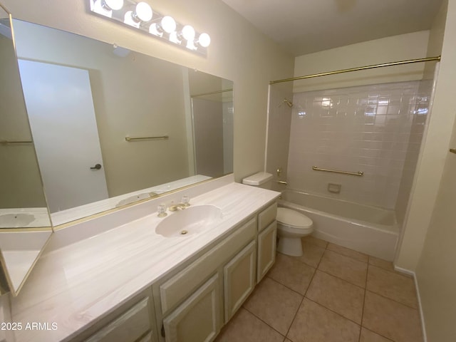 bathroom featuring tile patterned flooring, toilet, vanity, and washtub / shower combination