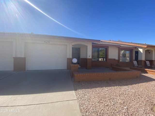 ranch-style house with brick siding, driveway, and an attached garage