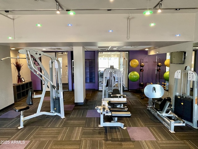 gym with carpet flooring, rail lighting, recessed lighting, and baseboards