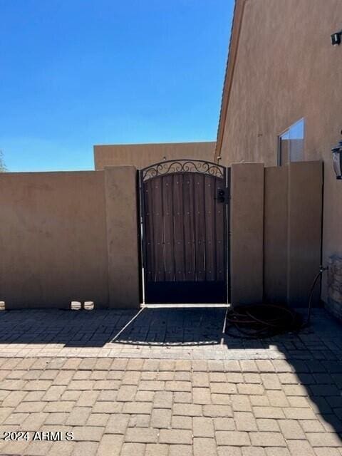 view of gate with fence