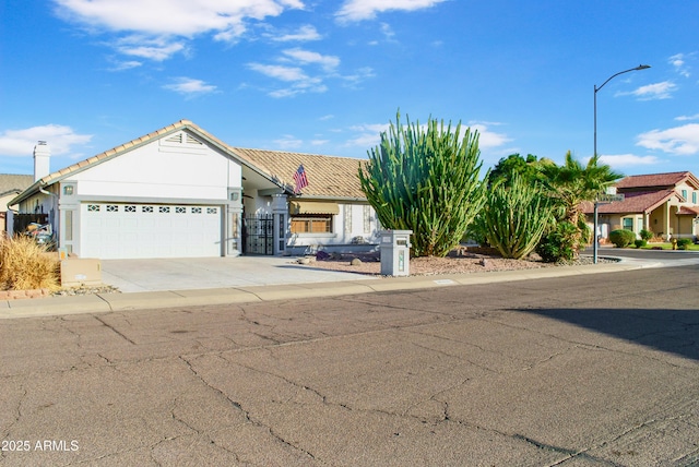 ranch-style house featuring driveway, an attached garage, and stucco siding