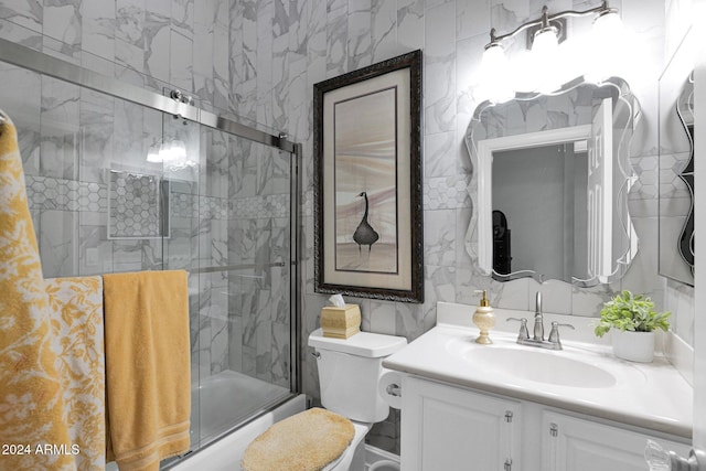 full bathroom with vanity, toilet, and bath / shower combo with glass door