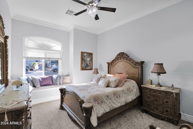 carpeted bedroom with ceiling fan and ornamental molding