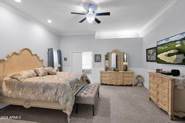 bedroom with carpet flooring, ceiling fan, ornamental molding, and connected bathroom