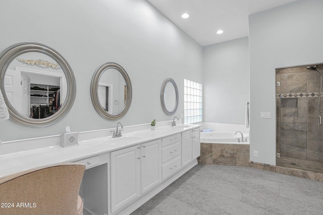 bathroom featuring tile patterned flooring, shower with separate bathtub, and vanity