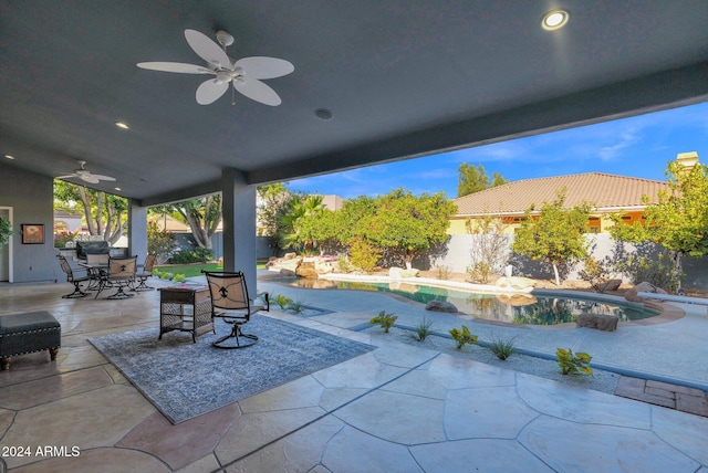 view of patio with a fenced in pool and ceiling fan