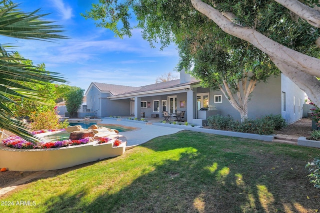 view of front facade with a patio area and a front yard