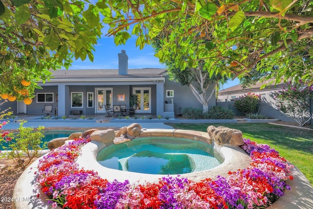 view of pool featuring a patio area, an in ground hot tub, and french doors