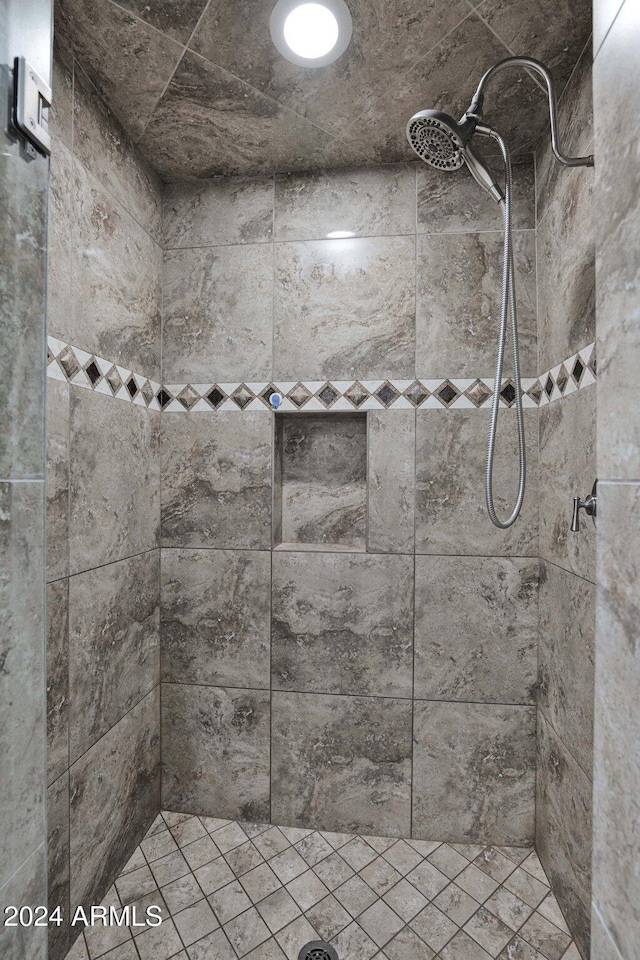 bathroom with a tile shower