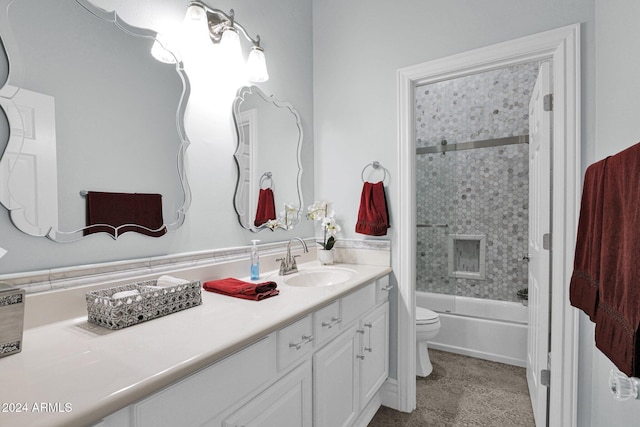 full bathroom with vanity, tiled shower / bath combo, and toilet