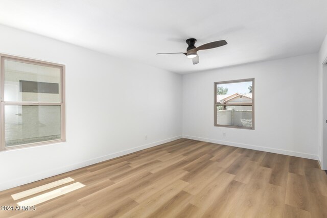 empty room featuring ceiling fan and light hardwood / wood-style floors