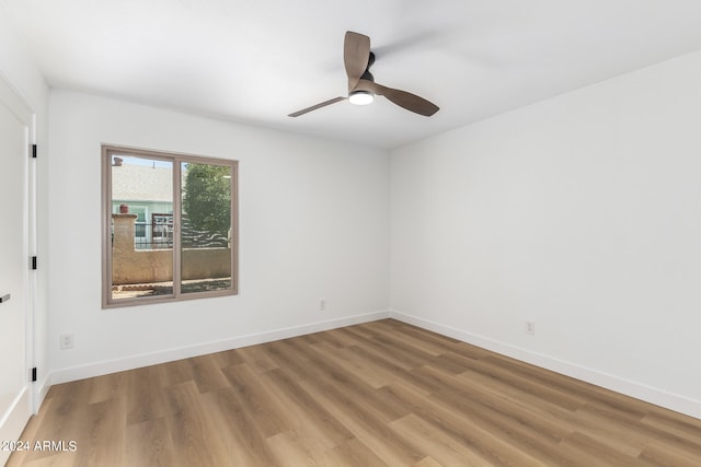 spare room featuring wood-type flooring and ceiling fan