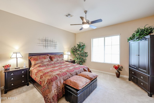 bedroom featuring light carpet, baseboards, visible vents, and a ceiling fan