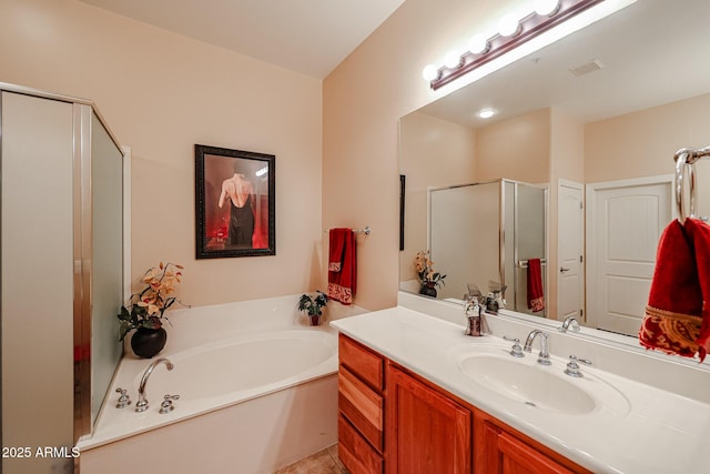 bathroom with vanity, visible vents, a garden tub, and a shower stall