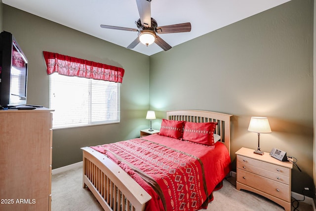 bedroom featuring light carpet, baseboards, and ceiling fan