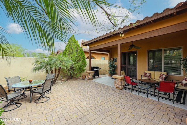 view of patio with a fenced backyard, outdoor dining space, grilling area, and a ceiling fan