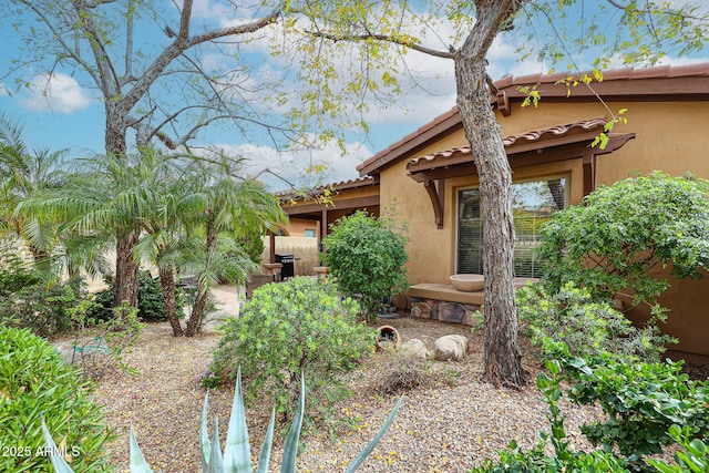 view of front of home featuring stucco siding and a tile roof