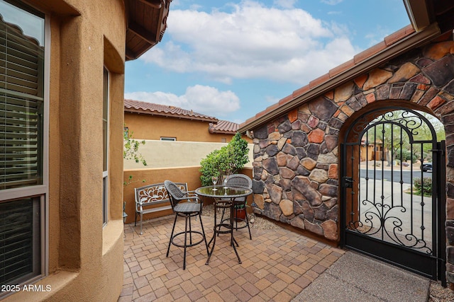 view of patio with a gate