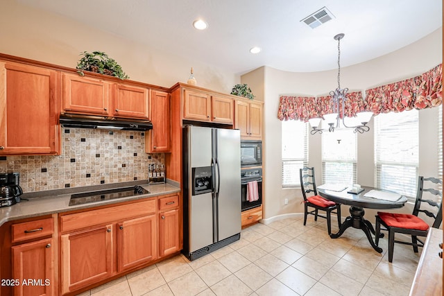 kitchen featuring visible vents, tasteful backsplash, under cabinet range hood, black appliances, and a notable chandelier