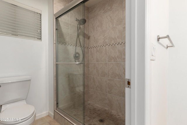 9809 W Behrend Dr, Peoria, AZ 85382 - bathroom featuring a shower stall, toilet, baseboards, and tile patterned floors
