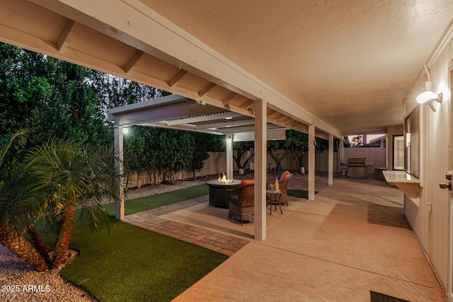 9809 W Behrend Dr, Peoria, AZ 85382 - view of patio / terrace with a fire pit and a fenced backyard