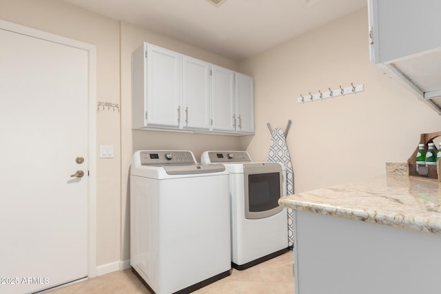 9809 W Behrend Dr, Peoria, AZ 85382 - laundry room featuring washing machine and clothes dryer, cabinet space, and light tile patterned floors