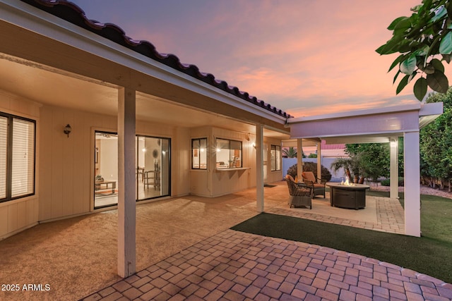 9809 W Behrend Dr, Peoria, AZ 85382 - patio terrace at dusk with an outdoor fire pit