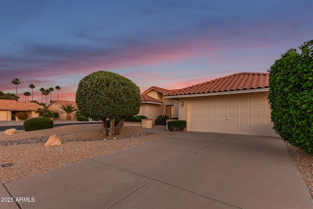 9809 W Behrend Dr, Peoria, AZ 85382 - mediterranean / spanish-style house featuring driveway, a tiled roof, a garage, and stucco siding