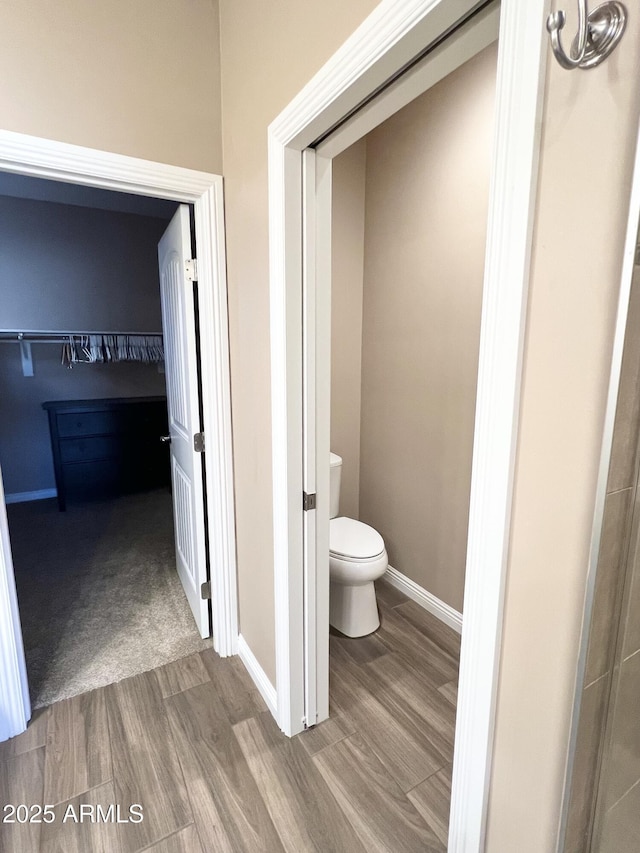 6145 E Cave Creek Rd Unit 203, Cave Creek, AZ 85331 - bathroom featuring wood finished floors, toilet, and baseboards